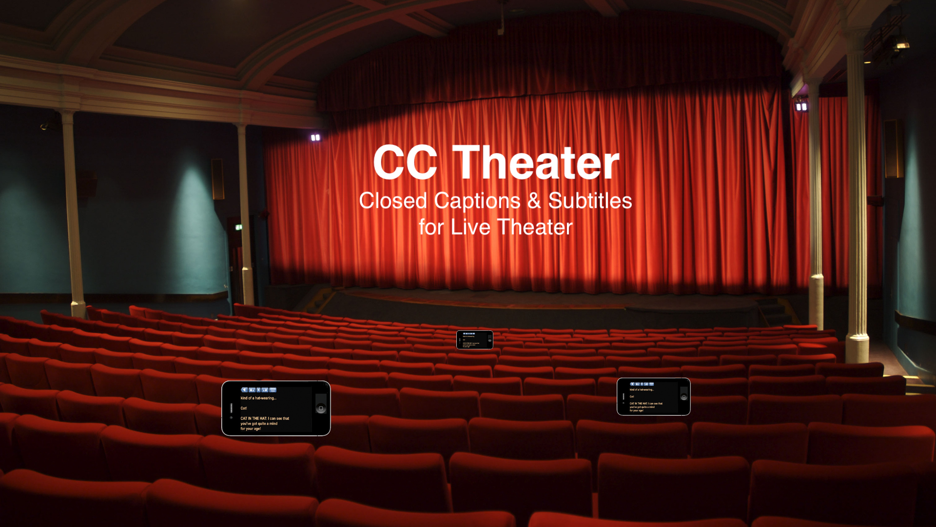 A theater interior. There are iphones at a few seats showing captions.